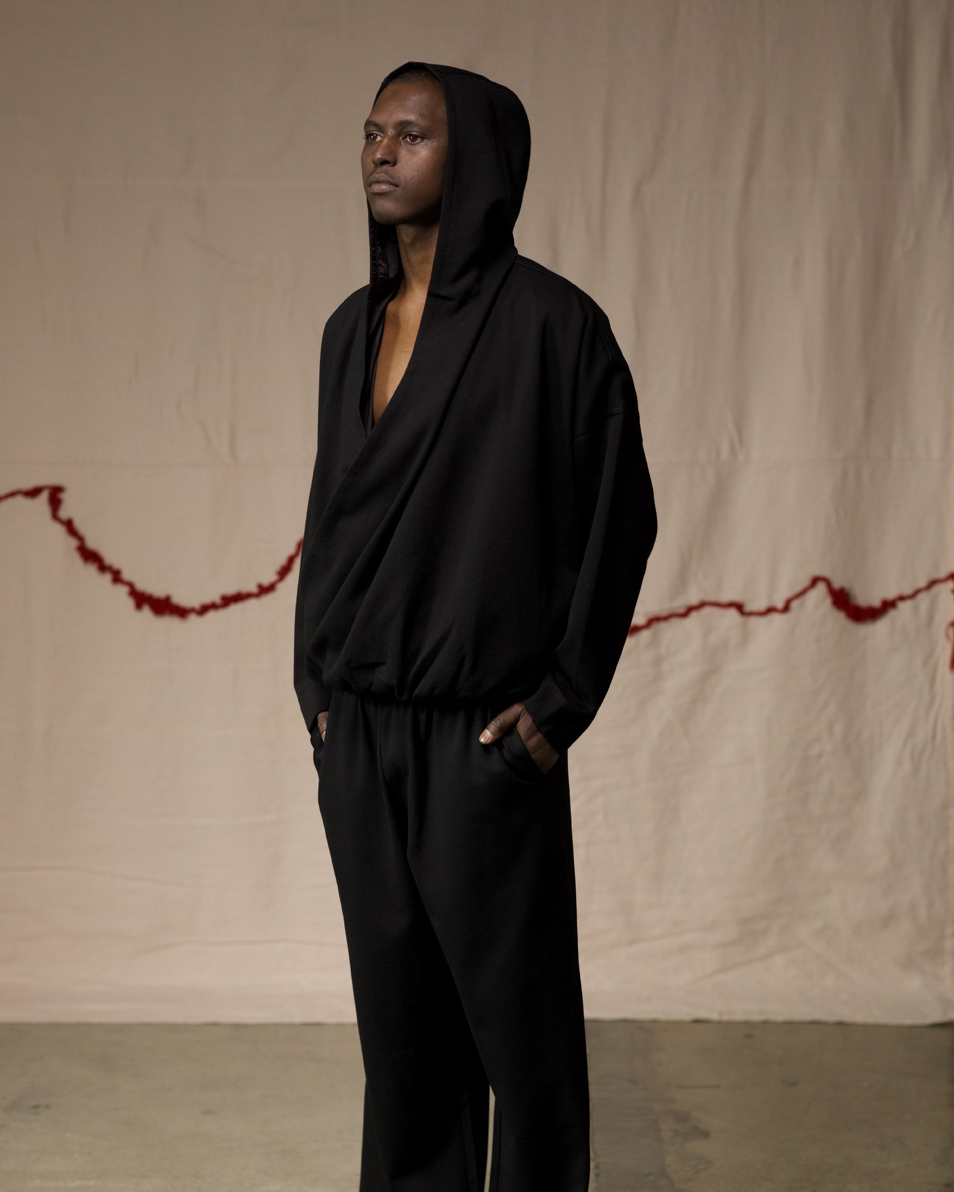 Side View of Black Hooded Wrap Top by Mind Less
